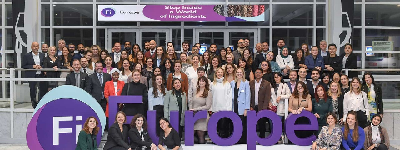 Informa team photo by Fi Europe sign